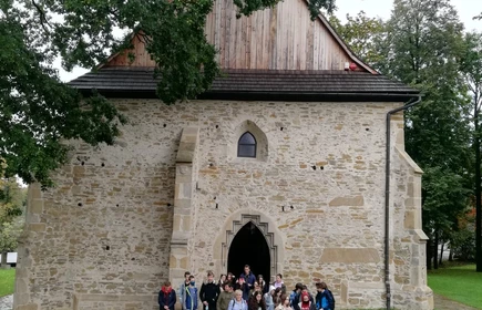 Grupowe zdjęcie uczniów opuszczających zabytkowy budynek