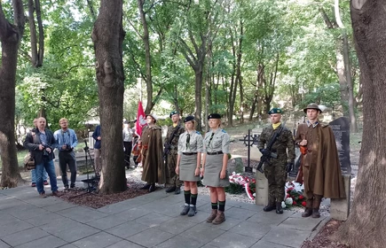 harcerze i żołnierze stojący przy pomniku