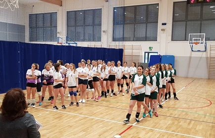 zdjęcie 3 drużyn siatkarskich dziewczyn na hali sportowej.